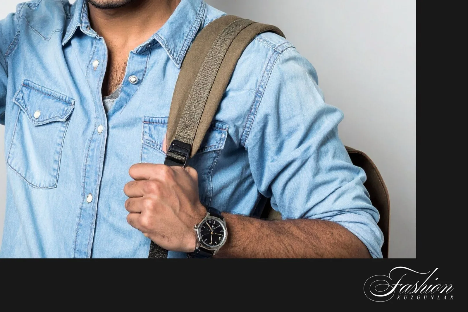 Sırt çantası askısıyla açık mavi denim gömlek giyen erkek