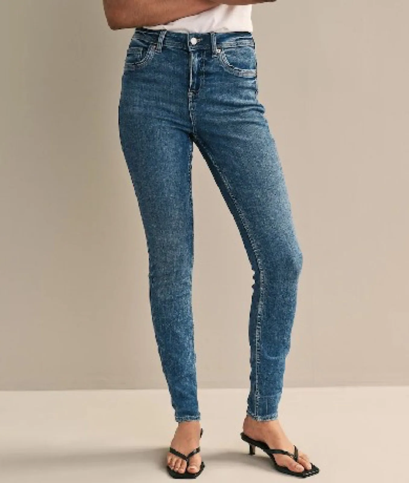 Orta yıkama yüksek bel skinny kot giyen kadın